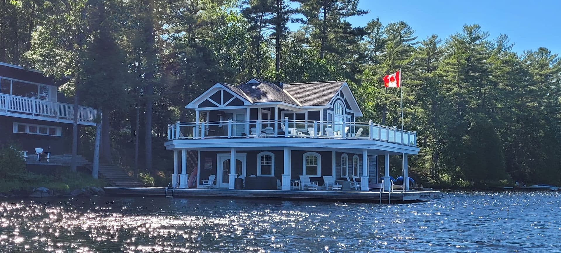 Two-Storey Boathouse in Navy & White: boathouse exterior painting in Muskoka Lakes, Muskoka, Ontario